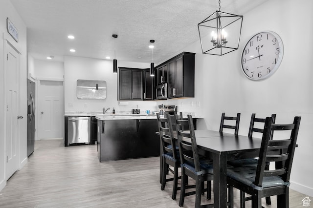 347 N 750 E, Vineyard, UT 84059 - dining room featuring light wood-style floors, a chandelier, baseboards, recessed lighting, and a textured ceiling