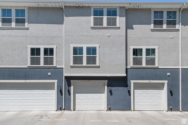 347 N 750 E, Vineyard, UT 84059 - view of front facade featuring stucco siding, an attached garage, and driveway