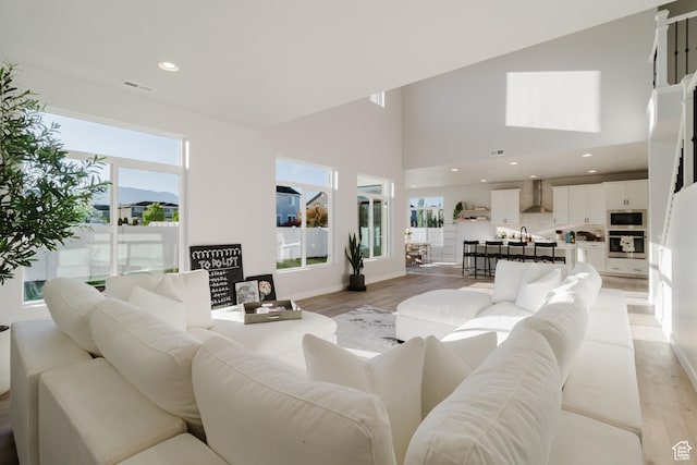 903 S 250 W, American Fork, UT 84003 - living area featuring light wood finished floors, a towering ceiling, and recessed lighting