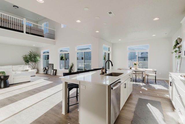 903 S 250 W, American Fork, UT 84003 - kitchen with dishwasher, light wood finished floors, an island with sink, white cabinetry, and recessed lighting
