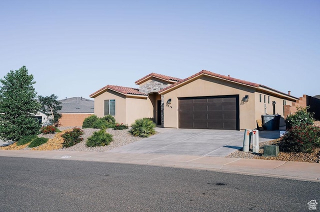 579 N Staci Dr, Hurricane, UT 84737 - mediterranean / spanish house with stucco siding, a garage, a tiled roof, and driveway