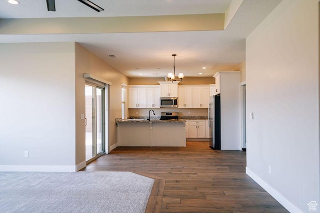 579 N Staci Dr, Hurricane, UT 84737 - kitchen featuring appliances with stainless steel finishes, white cabinets, a peninsula, a chandelier, and open floor plan