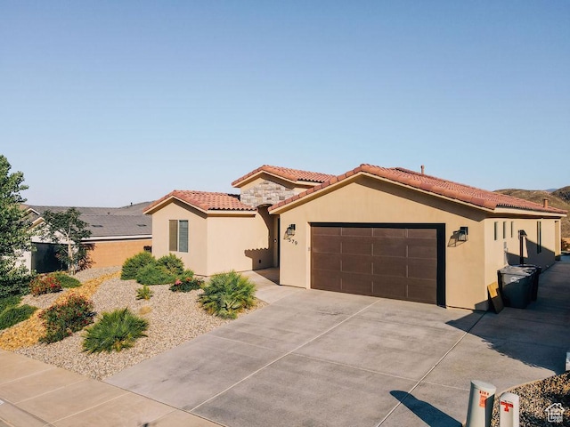 579 N Staci Dr, Hurricane, UT 84737 - mediterranean / spanish home with a garage, stucco siding, concrete driveway, and a tile roof