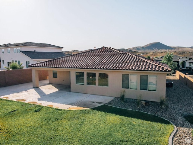 579 N Staci Dr, Hurricane, UT 84737 - back of house featuring stucco siding, a fenced backyard, a tiled roof, a patio area, and a mountain view