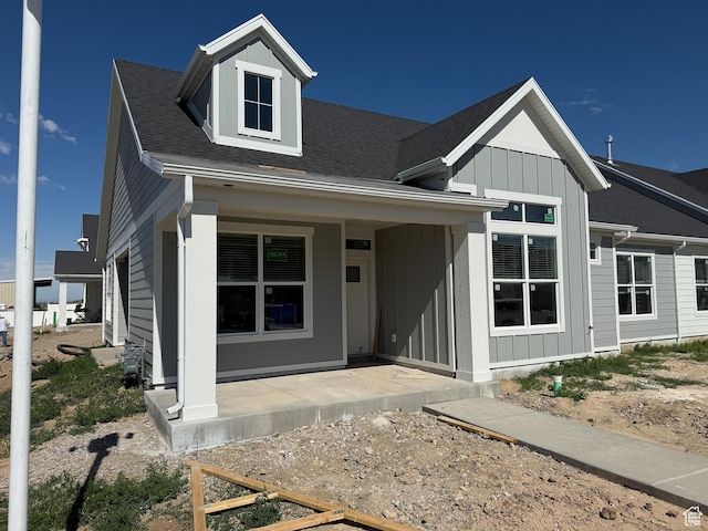 28 S 3830 W Unit 424, West Point, UT 84015 - view of front facade with covered porch, a shingled roof, and board and batten siding