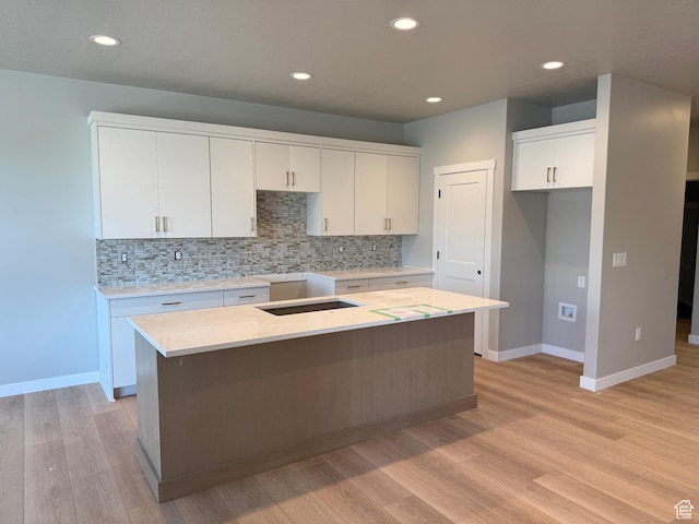 28 S 3830 W Unit 424, West Point, UT 84015 - kitchen featuring a kitchen island, decorative backsplash, white cabinets, light wood finished floors, and recessed lighting