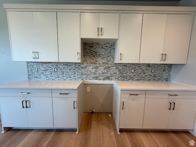 28 S 3830 W Unit 424, West Point, UT 84015 - kitchen with light wood finished floors, decorative backsplash, and white cabinets