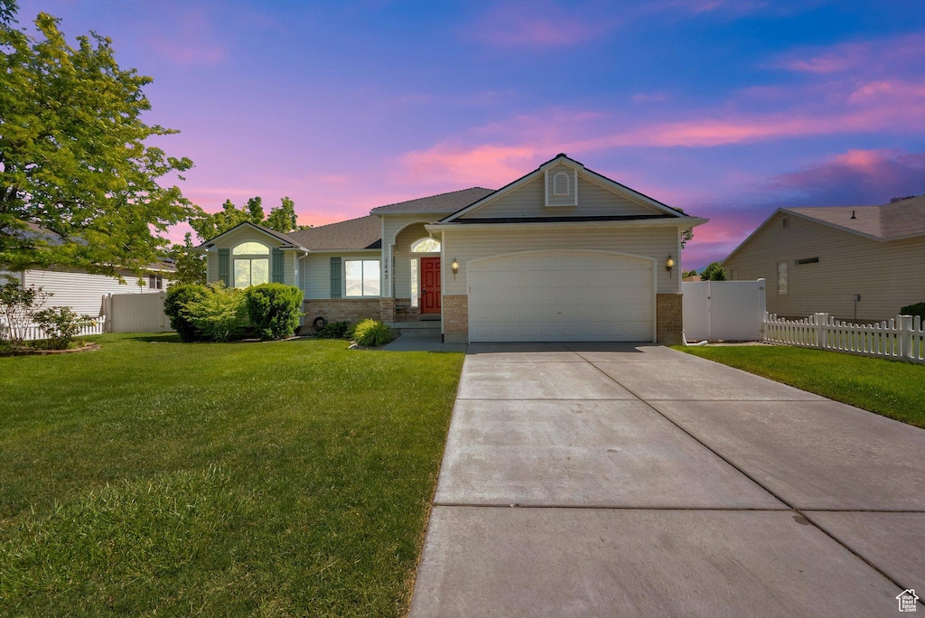 7443 W Perennial Dr, Magna, UT 84044 - ranch-style home with an attached garage, concrete driveway, and brick siding