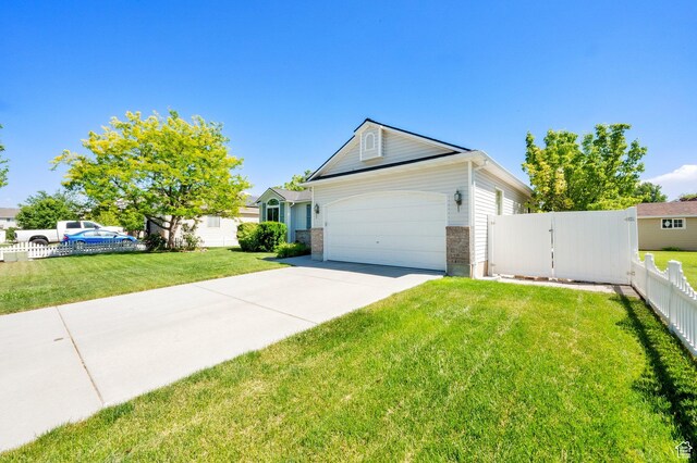 7443 W Perennial Dr, Magna, UT 84044 - view of front of house with concrete driveway, a garage, and brick siding