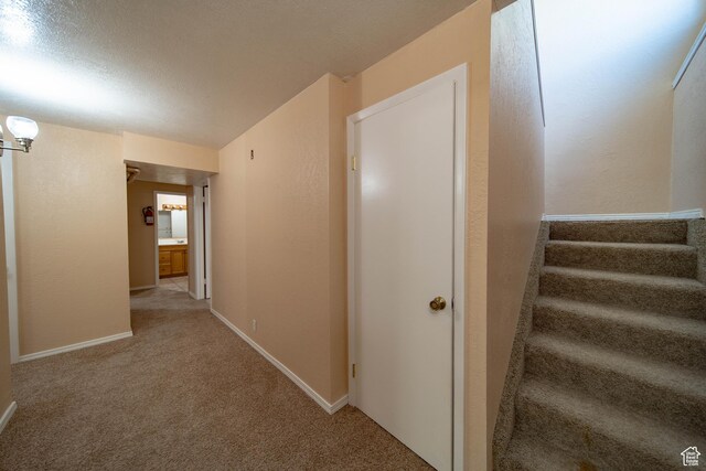 617 Aspen Cir, Price, UT 84501 - corridor with carpet floors and stairway
