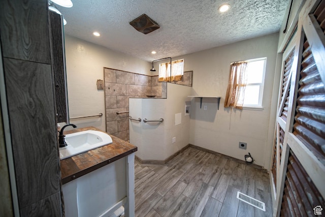 617 Aspen Cir, Price, UT 84501 - bathroom with vanity, a textured ceiling, wood finished floors, and recessed lighting