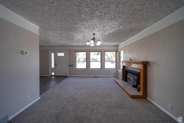 617 Aspen Cir, Price, UT 84501 - unfurnished living room with a chandelier, carpet, a textured ceiling, a glass covered fireplace, and a textured wall