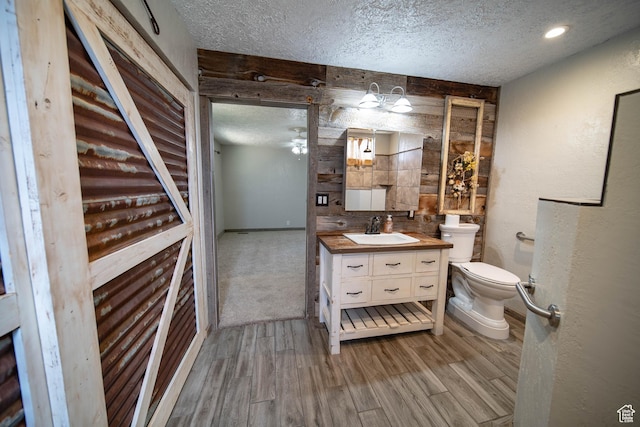 617 Aspen Cir, Price, UT 84501 - bathroom with a textured ceiling, vanity, wood finished floors, and ceiling fan