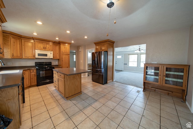 617 Aspen Cir, Price, UT 84501 - kitchen with electric range, white microwave, stainless steel refrigerator with ice dispenser, dark countertops, and a kitchen island