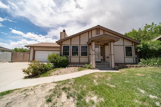 617 Aspen Cir, Price, UT 84501 - view of front of house featuring a chimney, concrete driveway, an attached garage, and a gate