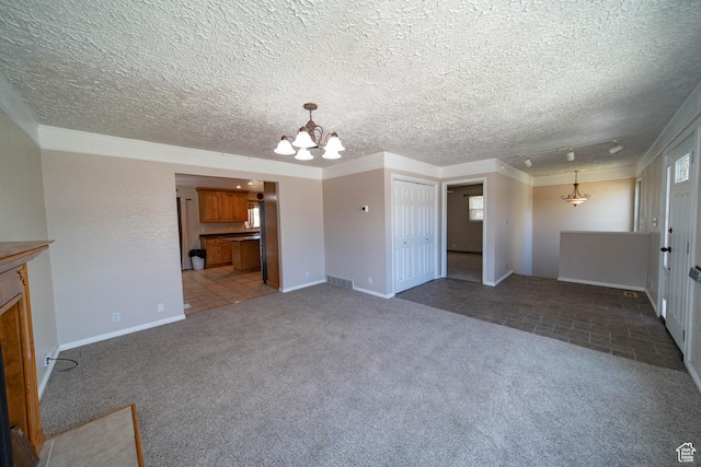 617 Aspen Cir, Price, UT 84501 - unfurnished living room with a chandelier, carpet floors, and a textured ceiling