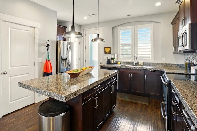 4746 W Daybreak Rim Way S, Jordan, UT 84009 - kitchen with stainless steel appliances, dark wood-style flooring, recessed lighting, dark brown cabinetry, and decorative light fixtures