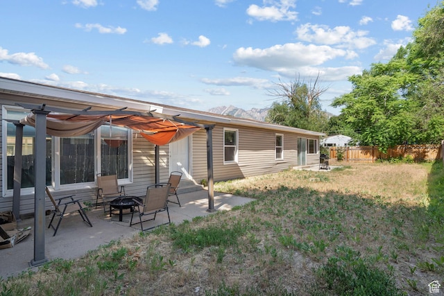 1866 E Village Rd S, Salt Lake City, UT 84121 - back of house featuring a fire pit, a patio area, and a mountain view