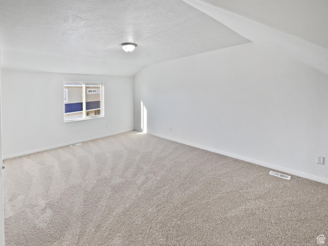 2238 N Harvest Moon Dr, Saratoga Springs, UT 84045 - carpeted empty room with a textured ceiling and lofted ceiling