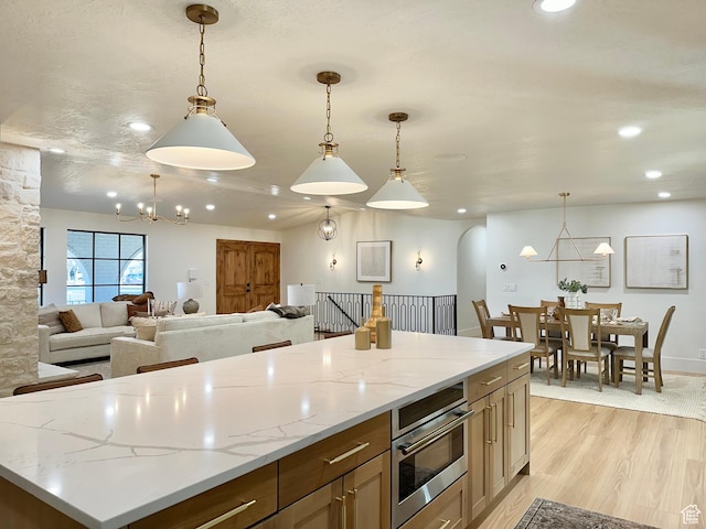 5862 S Ayrshire Dr, Murray, UT 84107 - kitchen with a chandelier, recessed lighting, light wood-style floors, open floor plan, and hanging light fixtures