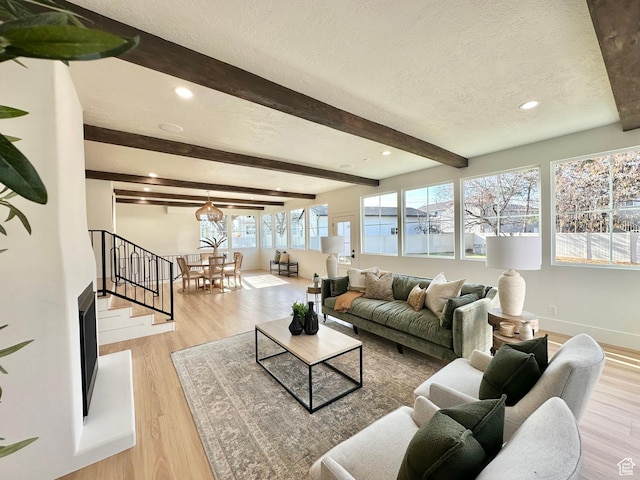 5862 S Ayrshire Dr, Murray, UT 84107 - living area featuring a textured ceiling, beam ceiling, light wood-style flooring, recessed lighting, and stairs
