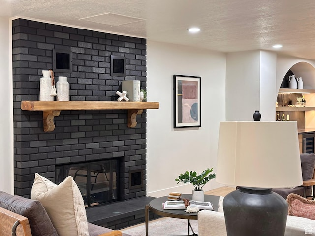 5862 S Ayrshire Dr, Murray, UT 84107 - living area featuring a fireplace, a textured ceiling, recessed lighting, and wood finished floors