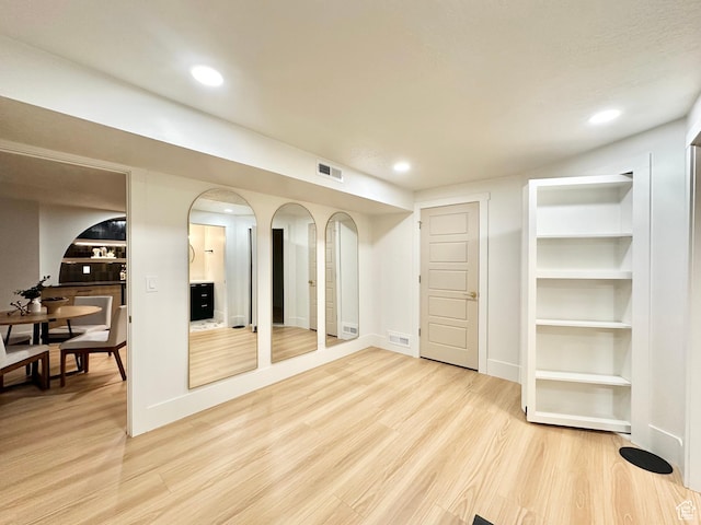 5862 S Ayrshire Dr, Murray, UT 84107 - basement featuring light wood-style floors, recessed lighting, and arched walkways