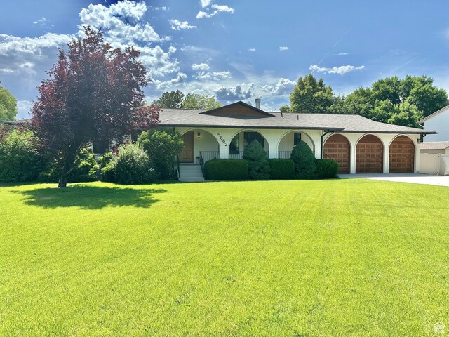 5862 S Ayrshire Dr, Murray, UT 84107 - view of front of property with a front yard, a garage, driveway, and a porch