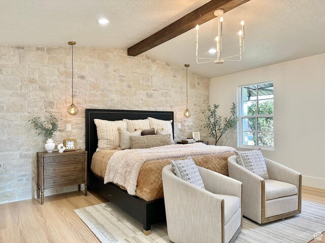 5862 S Ayrshire Dr, Murray, UT 84107 - bedroom with light wood-style floors, a multi sided fireplace, a chandelier, and a textured ceiling