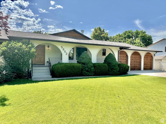 5862 S Ayrshire Dr, Murray, UT 84107 - view of front of home with a porch, a front yard, driveway, and brick siding
