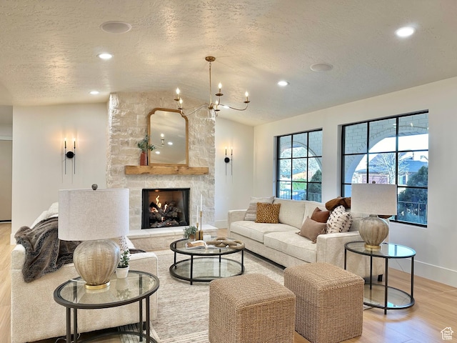 5862 S Ayrshire Dr, Murray, UT 84107 - living area with light wood-style floors, a textured ceiling, recessed lighting, a stone fireplace, and a chandelier