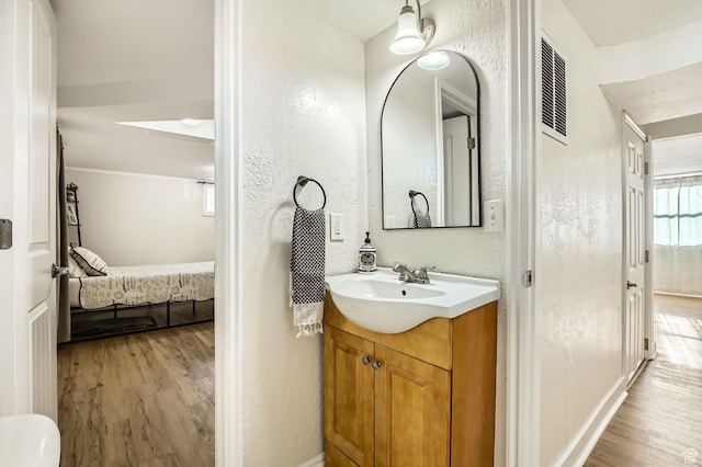 293 E 4800 S, Murray, UT 84107 - ensuite bathroom featuring wood finished floors, vanity, and a textured wall