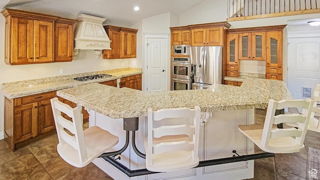 1812 E 1460 S, Spanish Fork, UT 84660 - kitchen with custom exhaust hood, appliances with stainless steel finishes, brown cabinetry, a breakfast bar, and recessed lighting