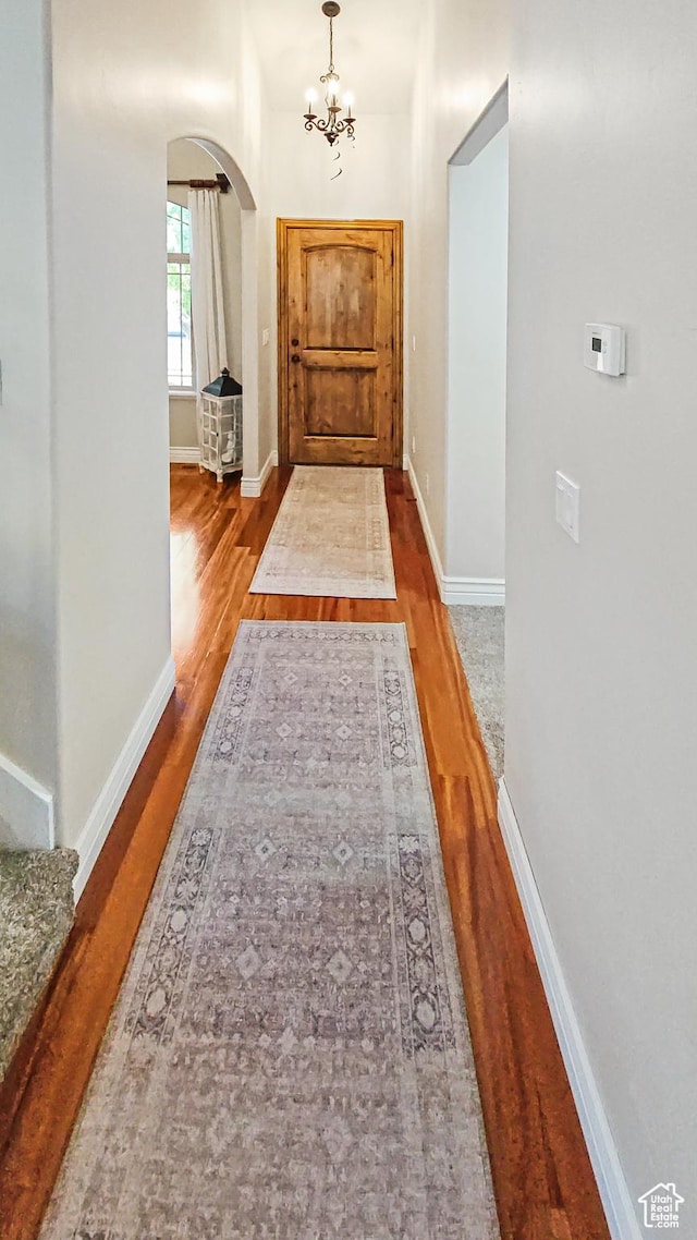 1812 E 1460 S, Spanish Fork, UT 84660 - hallway with arched walkways, wood finished floors, and a chandelier