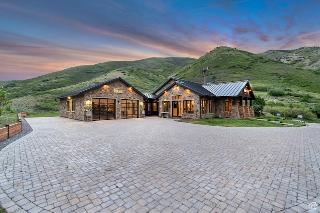 370 S Got Teeth Ln E, Emigration Canyon, UT 84108 - chalet / cabin featuring stone siding, a standing seam roof, and an attached garage
