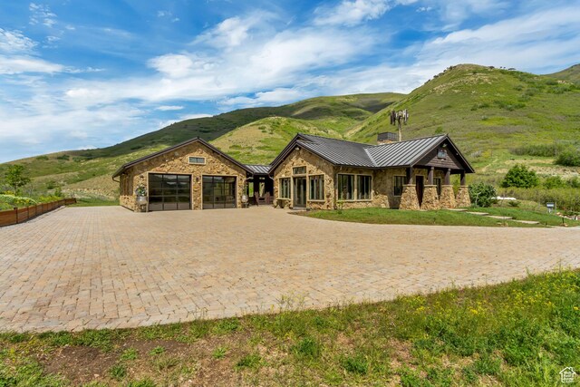 370 S Got Teeth Ln E, Emigration Canyon, UT 84108 - view of front facade with a standing seam roof, a mountain view, stone siding, and a metal roof