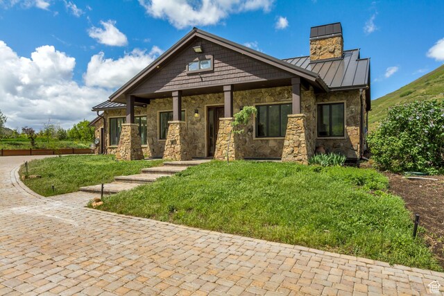370 S Got Teeth Ln E, Emigration Canyon, UT 84108 - craftsman house featuring a standing seam roof, stone siding, a chimney, a metal roof, and a front lawn