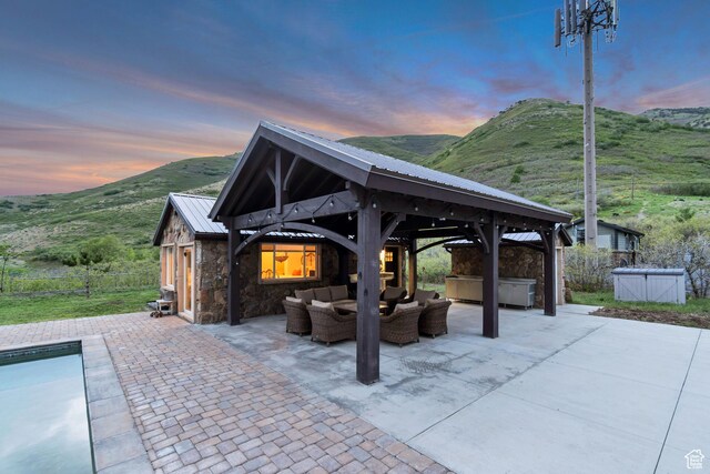 370 S Got Teeth Ln E, Emigration Canyon, UT 84108 - patio terrace at dusk featuring a gazebo, outdoor lounge area, a hot tub, and a patio area