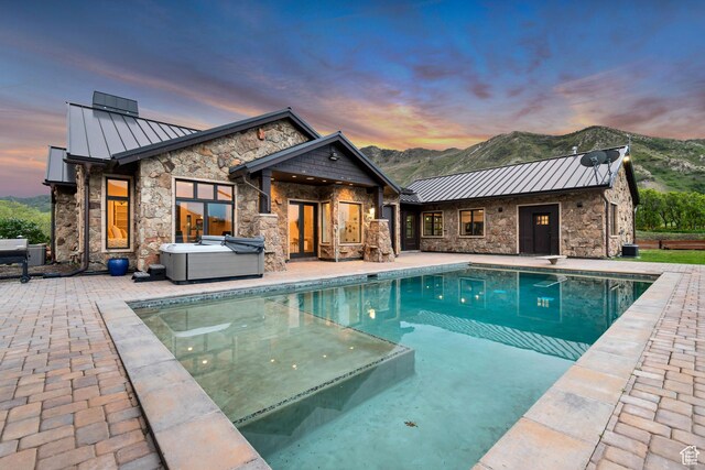 370 S Got Teeth Ln E, Emigration Canyon, UT 84108 - pool at dusk with a hot tub, a patio area, and an outdoor pool