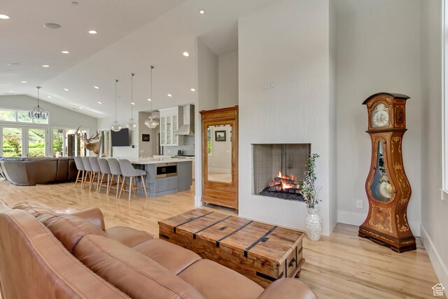 370 S Got Teeth Ln E, Emigration Canyon, UT 84108 - living room with light wood-style flooring, high vaulted ceiling, a lit fireplace, and recessed lighting
