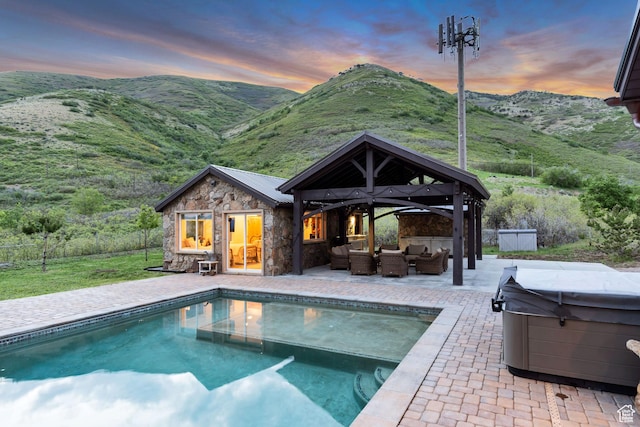 370 S Got Teeth Ln E, Emigration Canyon, UT 84108 - pool at dusk with an outdoor living space, a hot tub, an outdoor structure, and an outdoor pool