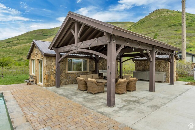 370 S Got Teeth Ln E, Emigration Canyon, UT 84108 - view of patio with a gazebo, a hot tub, an outdoor living space, and a mountain view