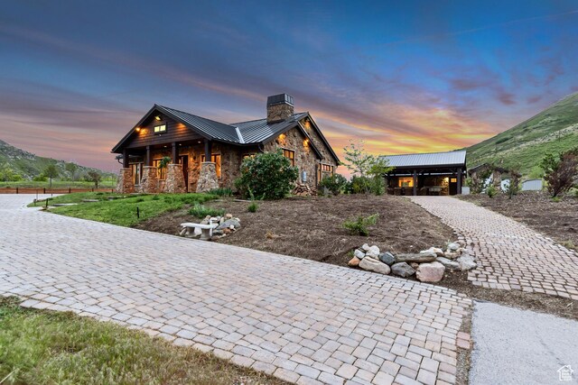 370 S Got Teeth Ln E, Emigration Canyon, UT 84108 - view of front of property featuring stone siding, a chimney, a standing seam roof, a metal roof, and a porch