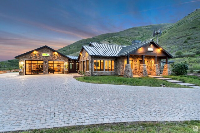 370 S Got Teeth Ln E, Emigration Canyon, UT 84108 - view of front facade with a standing seam roof, stone siding, an attached garage, and decorative driveway