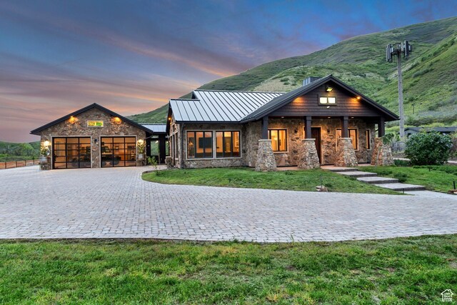 370 S Got Teeth Ln E, Emigration Canyon, UT 84108 - view of front of house featuring a standing seam roof, stone siding, an attached garage, decorative driveway, and a front yard