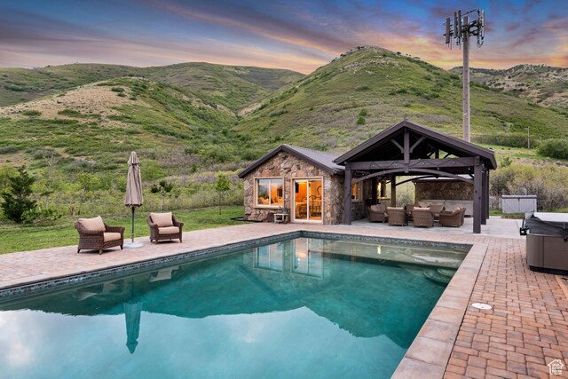 370 S Got Teeth Ln E, Emigration Canyon, UT 84108 - swimming pool featuring outdoor lounge area, an exterior structure, an outbuilding, a patio area, and a mountain view