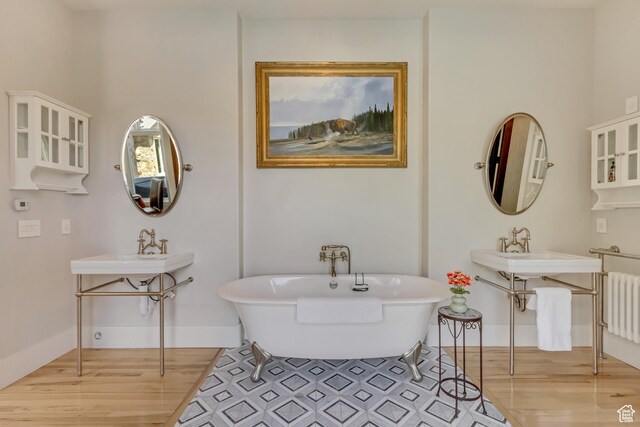 370 S Got Teeth Ln E, Emigration Canyon, UT 84108 - bathroom featuring wood finished floors, radiator, and a freestanding tub