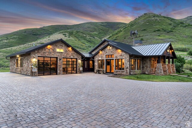 370 S Got Teeth Ln E, Emigration Canyon, UT 84108 - view of front facade featuring a standing seam roof, stone siding, a garage, and decorative driveway