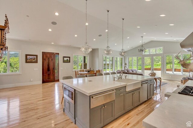 370 S Got Teeth Ln E, Emigration Canyon, UT 84108 - kitchen featuring a warming drawer, gray cabinetry, open floor plan, a chandelier, and a center island with sink