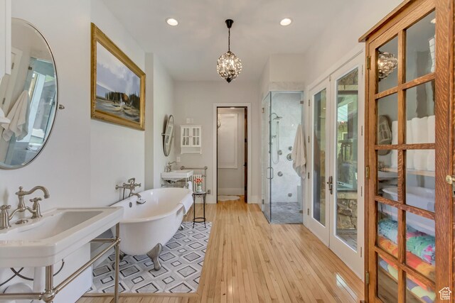 370 S Got Teeth Ln E, Emigration Canyon, UT 84108 - full bath with a shower stall, a freestanding bath, hardwood / wood-style flooring, a chandelier, and recessed lighting